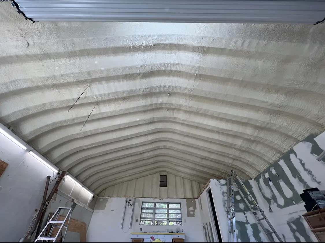 Spray polyurethane foam applied to the underside of a metal roof deck in Page